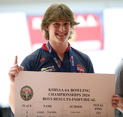 Joe holds the official results of the state bowling championship